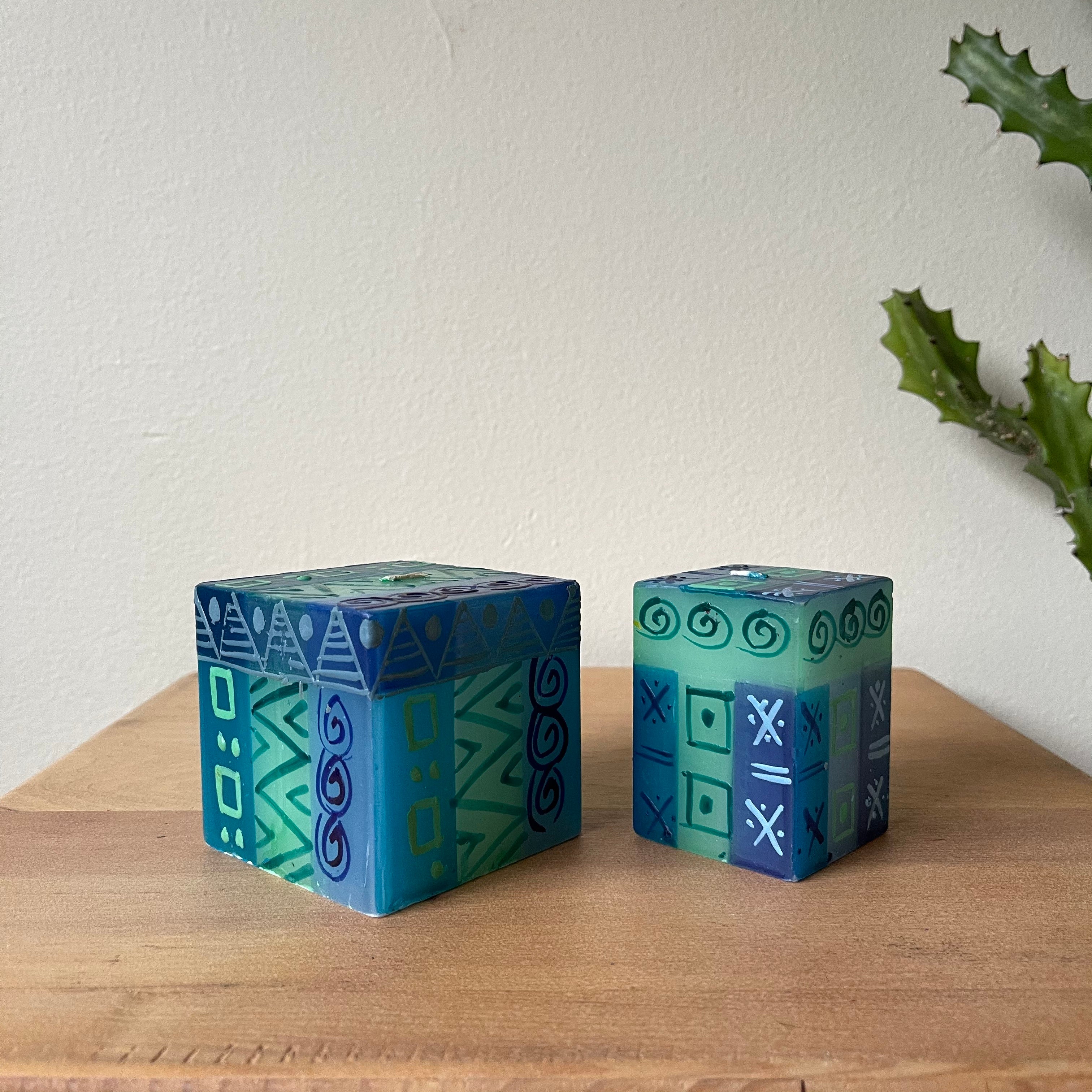 Blue & Green hand painted candle cubes.  3" x 3" x 3"cube and 2" x 2" x 3" cube.  Painted in a blue & green pattern with white highlights.