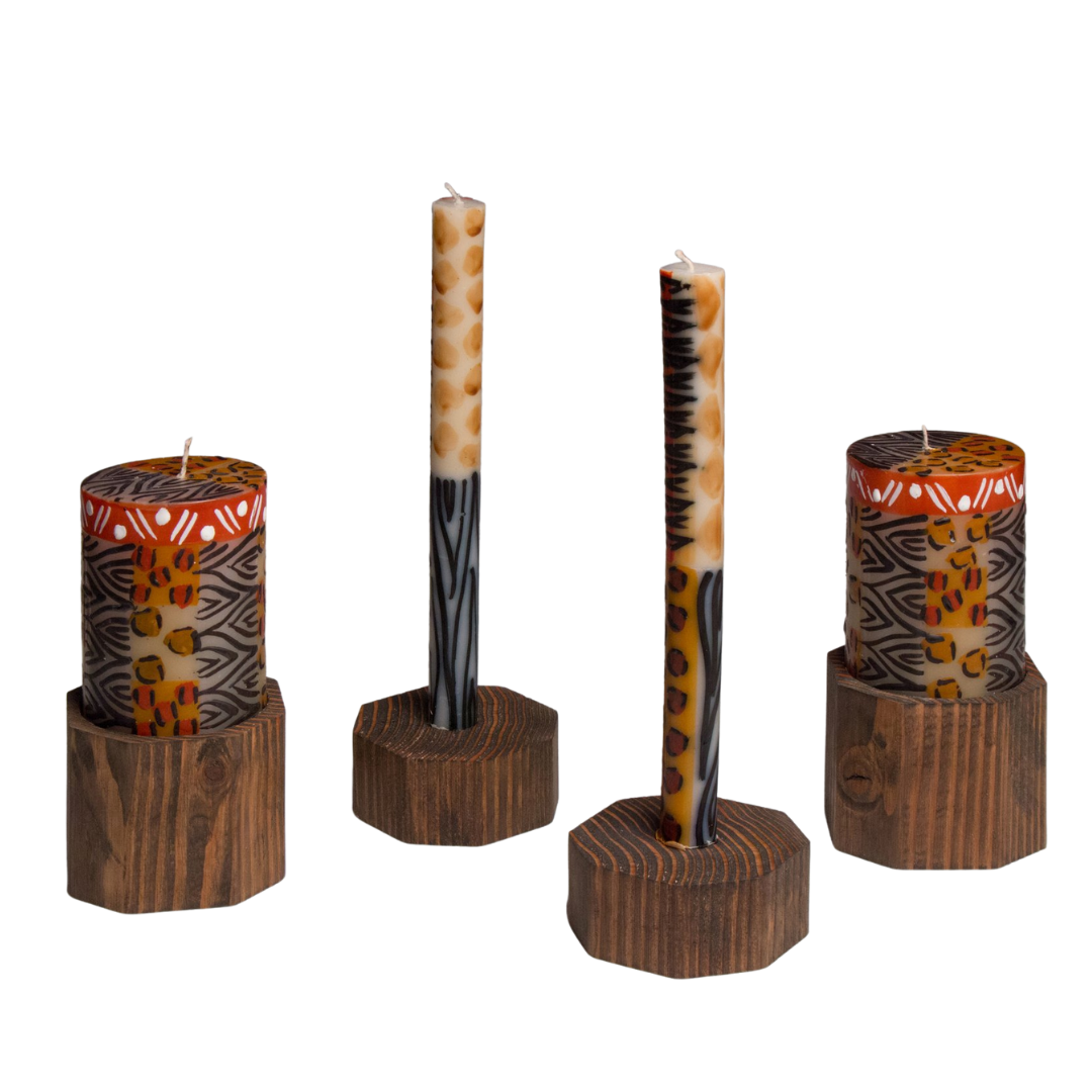 Animal Print candles; two 3" x 4" pillars and a taper candle pair,  on brown wood pillar & taper holders.  The same block of wood that holds the pillar can be turned upside down and hold a taper. Fair Trade.