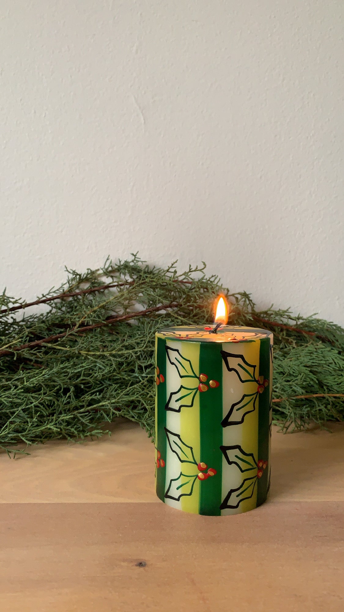 Christmas hand made and hand painted 3" x 4" pillar candle painted with holly leaves & berries and green stripe.  