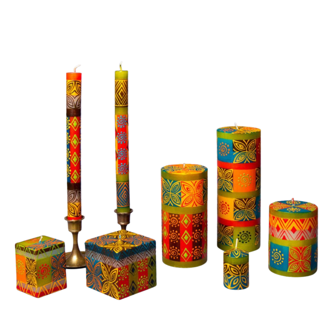 Desert Rose hand poured and hand painted candles made in South Africa. Fair trade home decor.  The Desert Rose candle collection is 2 cube candles, a pair of tapers, 3 pillar candles, and votives. Hand painted in reds, green, turquoise, browns, and yellow with floral and geometrical designs.