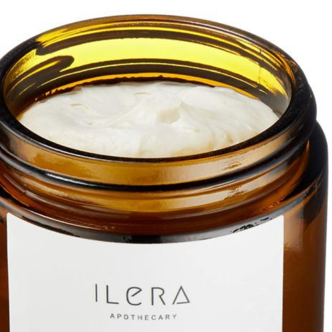 Open jar of ILERA apothecary cream that shows the richness of the cream. Fair Trade products.