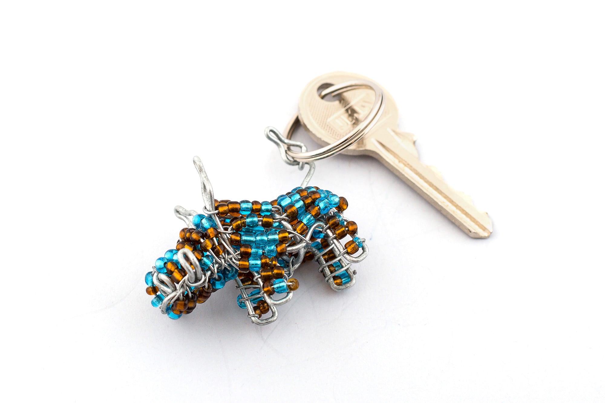 Adorable beaded warthog key chain.  Handmade with turquoise & brown beads.  Fair trade products.