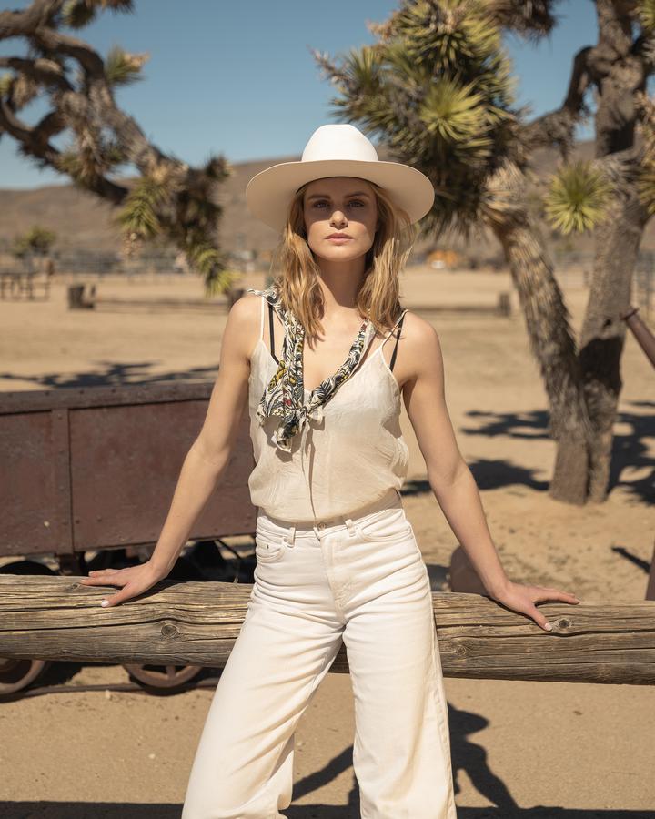 Woman in the desert (clothed!) with a Such is Life bandana tied around her neck looking sexy and rugged.