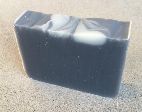 Coal Miner soap bar that is dark grey in color .