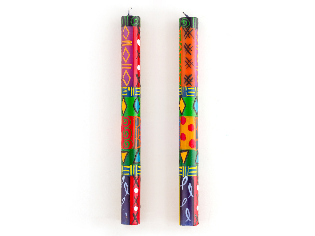 A matched pair of Multicolor Ethic taper candles, showing the detail of  the design work, all hand painted; stripes, dots, checks, fish, curls, diamonds, in all colors!