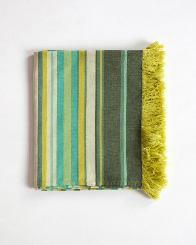 Seaweed Kikoi folded; striped with dark green, mustard yellow, turquoise blue and cream.