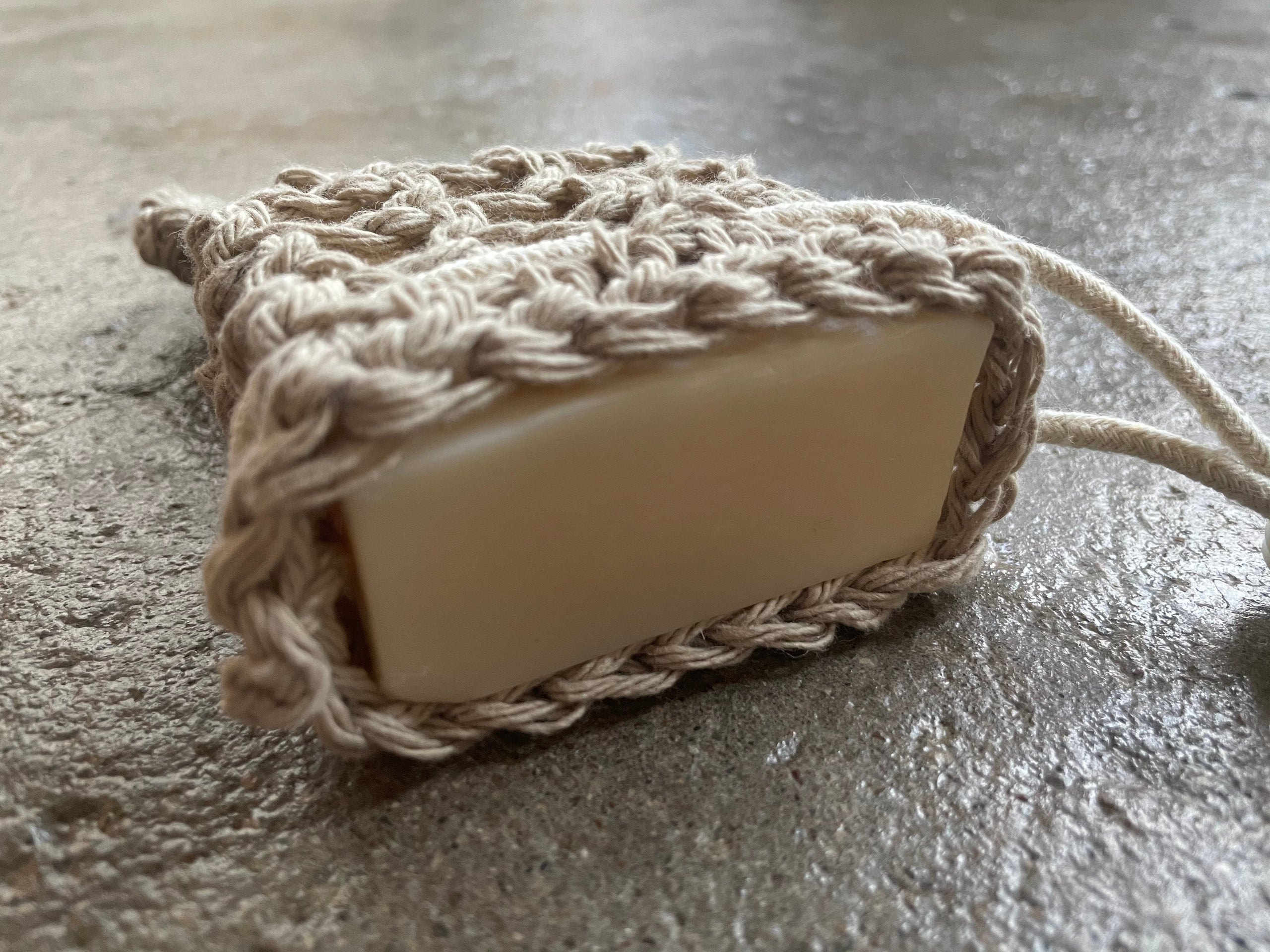 Hand woven soap saver that goes around the soap bar and acts as a gentle exfoliator.