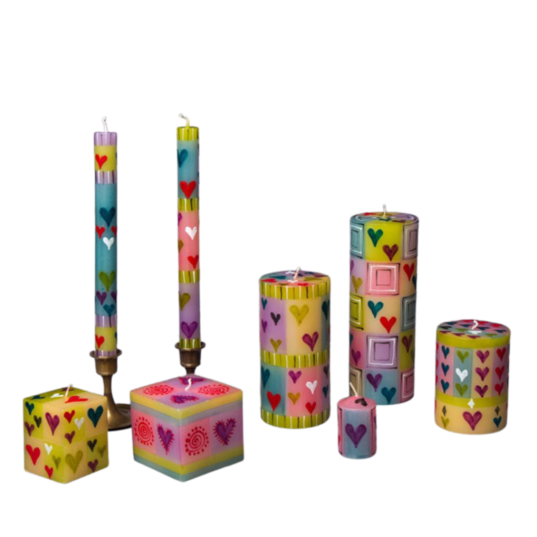 Pastel Hearts hand made & hand painted candle collection. Cube candles, taper candles, pillar candles and votives. all painted with hearts in pastel colors.