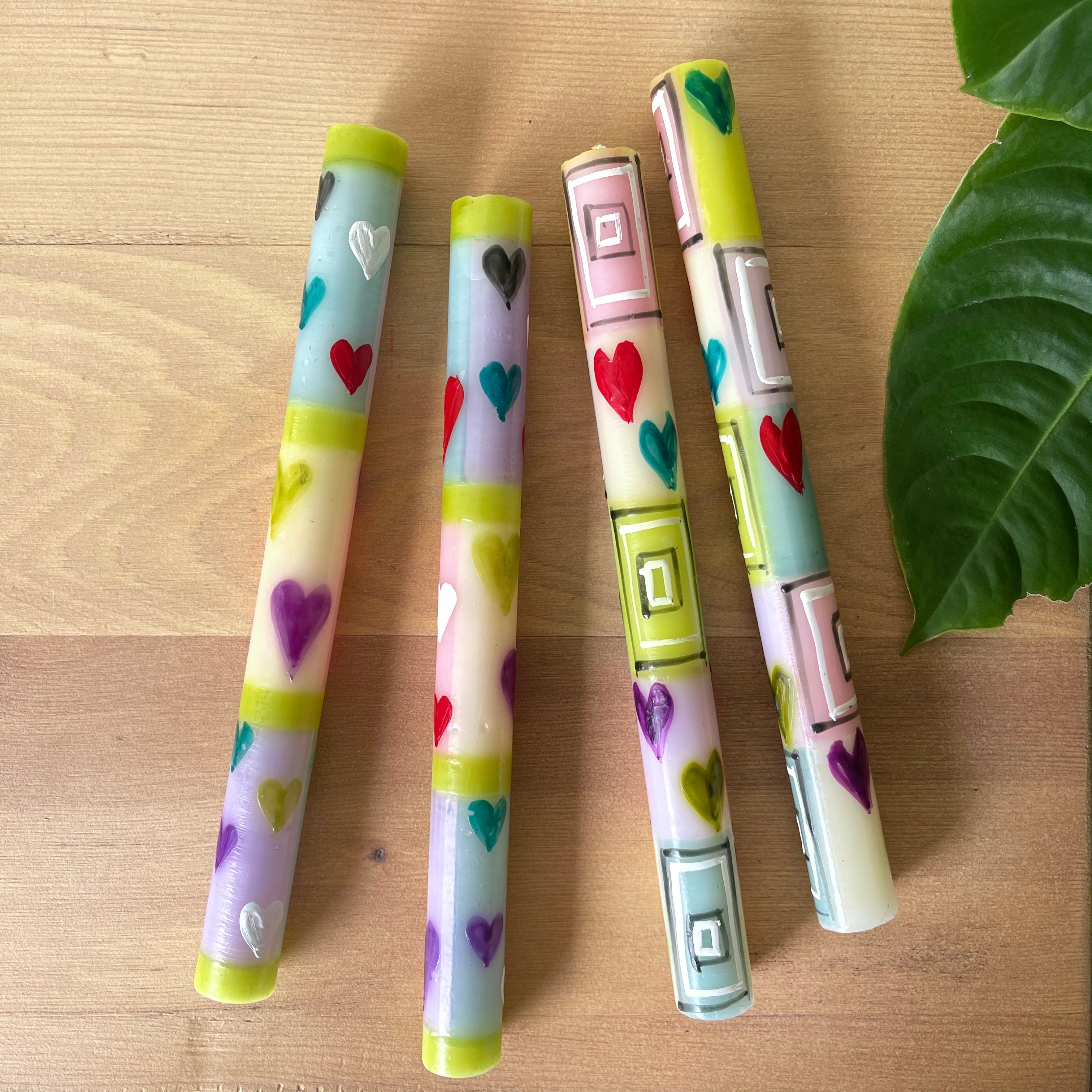 Two matching pairs of Pastel Heart taper candles.  Painted with hearts of various colors on pastel background.