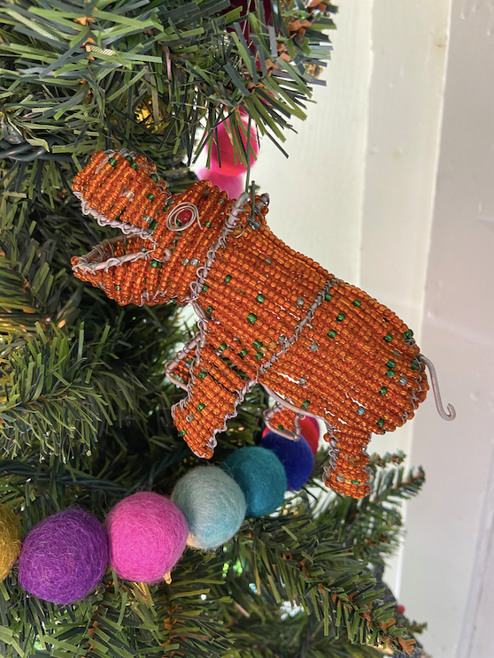 The hand beaded animals are fun to use as tree ornaments!  Here a red rhino with green dots!