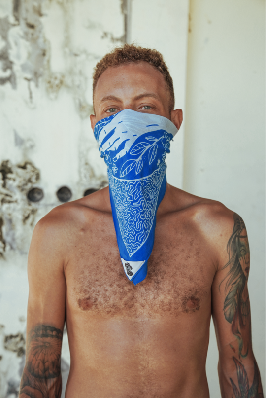 Man showing how the bandana works as a mask over nose & mouth
