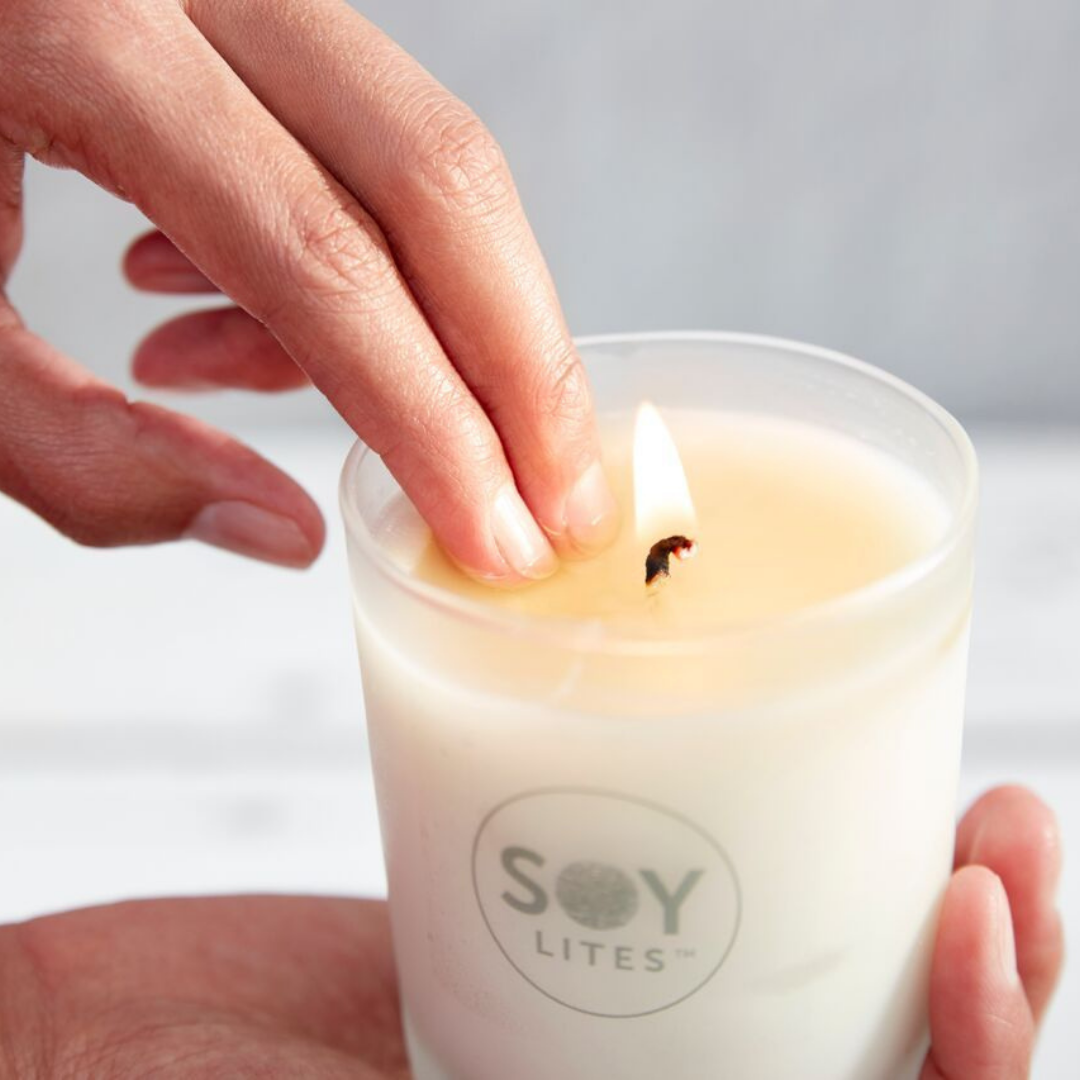 Dipping fingers into the melted wax of a Soylites tumbler - the wax is not hot and wonderful to use as a moisturizer