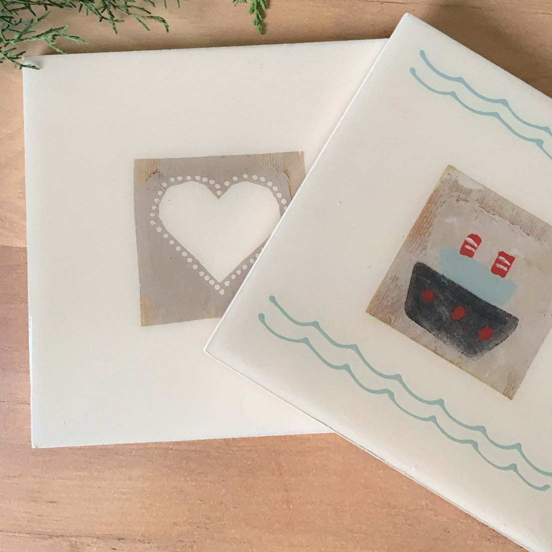 Trivets with recycled tea bags and designs. Heart and sailboat.