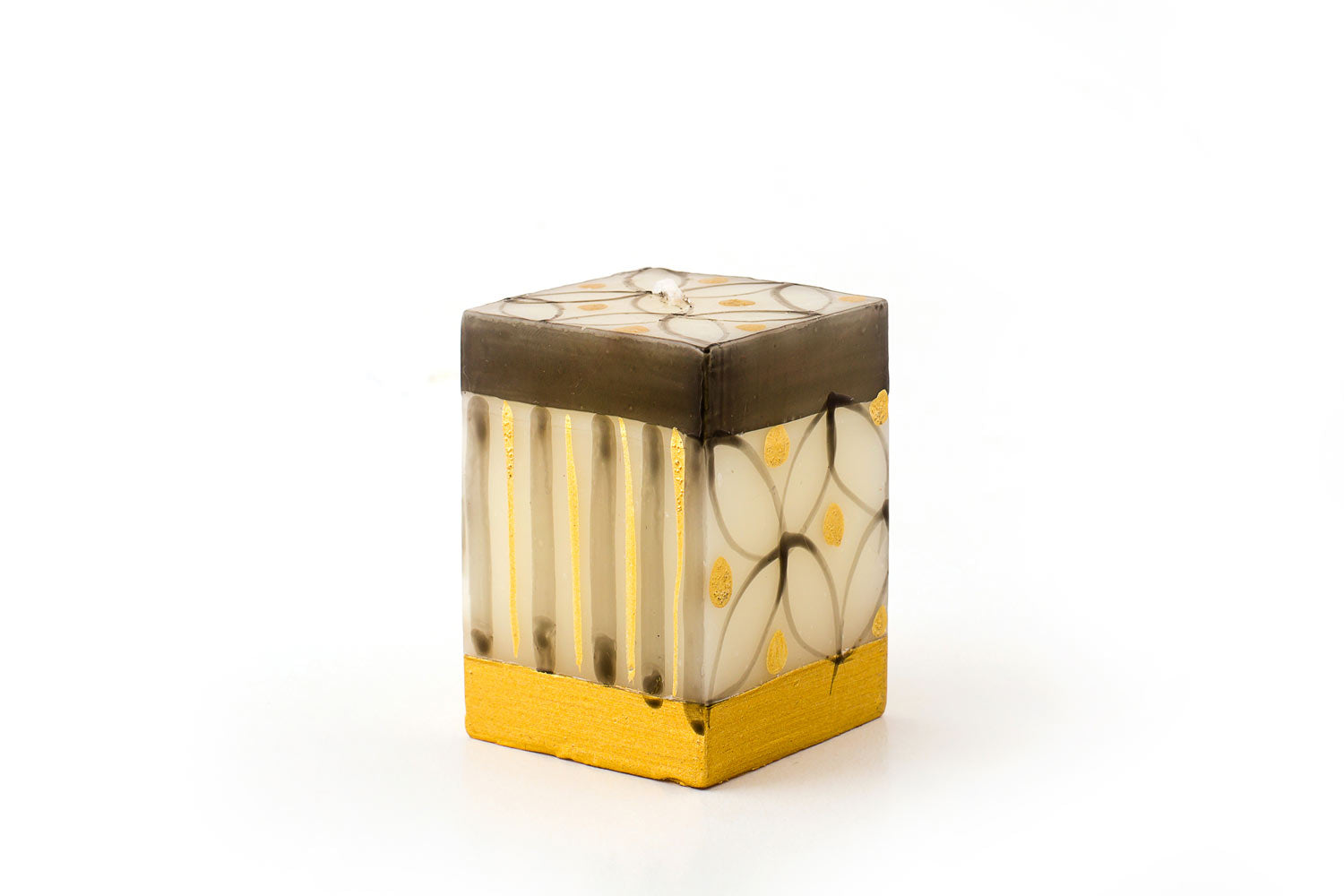 Celebration 2"x2"x3" cube candle.  White background with hand painted grey/black and gold design of stripes and flora.