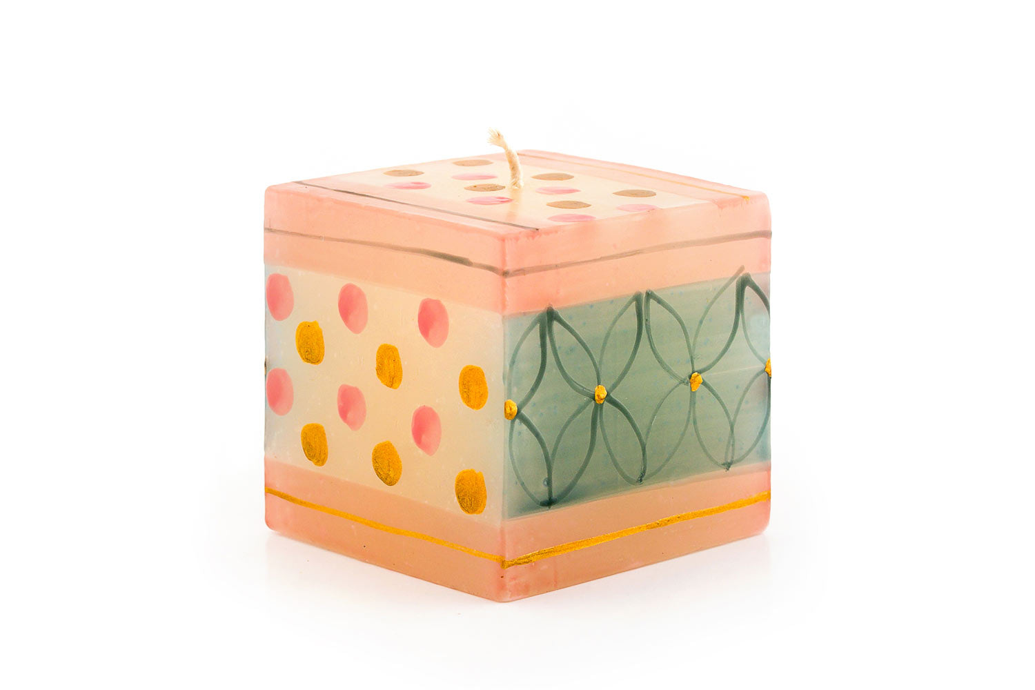 Delight 3x3x3inch cube candle with pink & gold dots on a cream color background on one side and top, turquoise with floral deco on the other side.  Hand painted, fair trade.