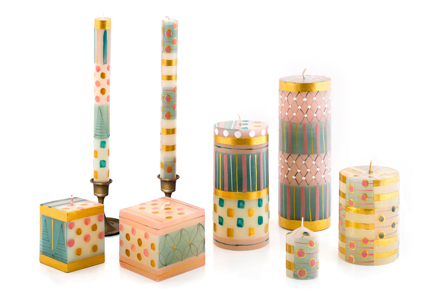 Delight hand poured and hand painted candle collection.  Stunning with pink, turquoise, and gold.  Available in taper pairs, pillars, cube candles and votive candle 6-pack. Fair Trade.