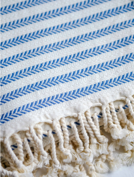 Close up photo of the Blue & White Turkish towel with white tassels that shows the weave and you can feel the softness! Fair Trade product.