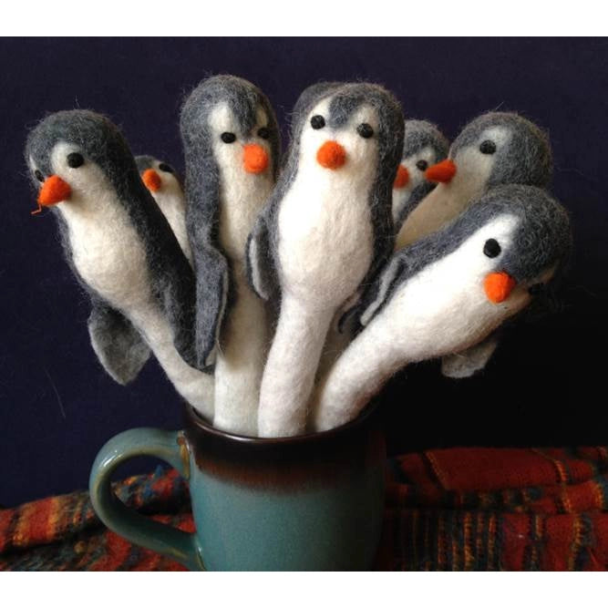 Several Penguin Pencil Toppers/Puppets on pencils in a mug.  Looks like a herd of penguins! Supper cute.