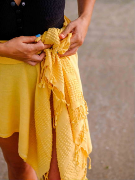 Yellow stone washed towel tied around the waist to show the versatility of the towels.