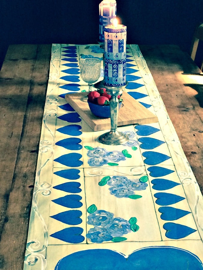 Table setting with a whimsy blue heart & roses table runner. Fair Trade