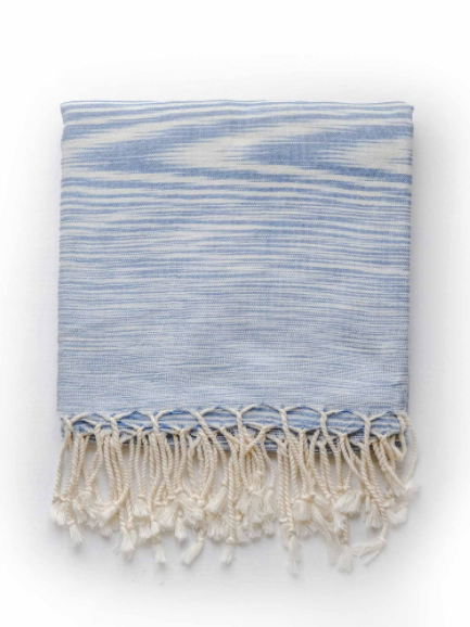 Folded blue zebra hand made Turkish Towel with cream fringe.