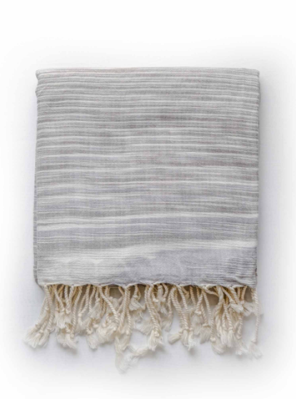 Folded hand made grey zebra Turkish Towel with cream fringe.